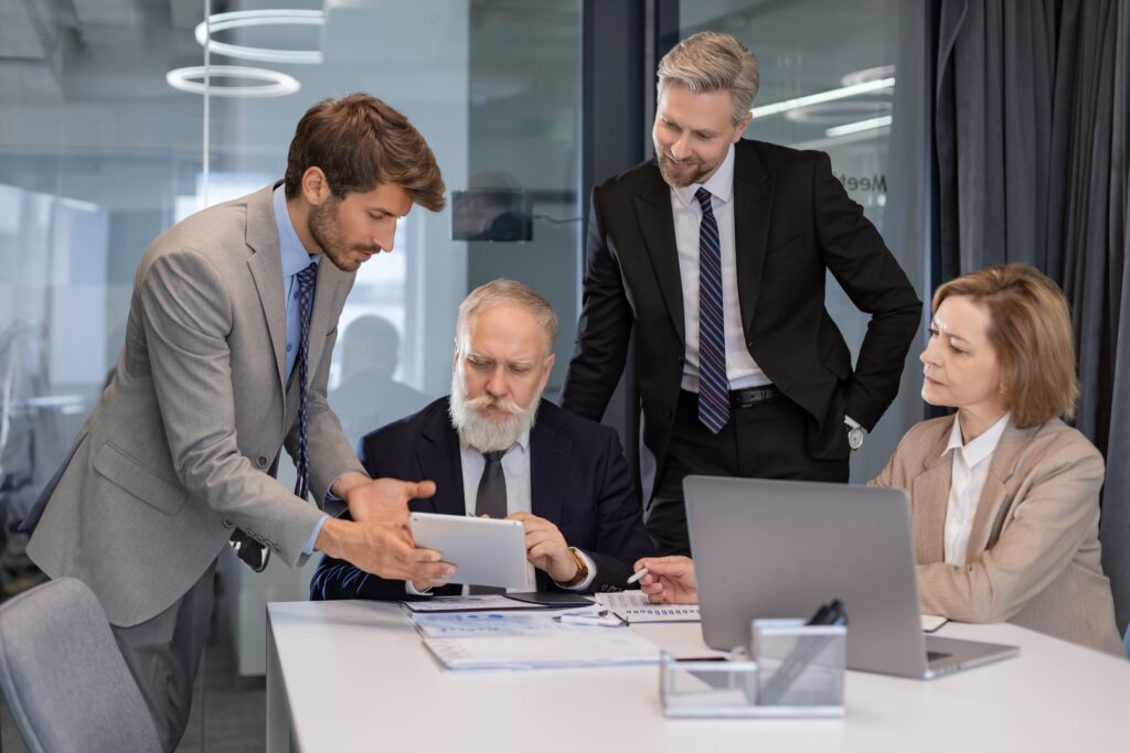 Group of young modern people using modern technologies while working in the modern office.