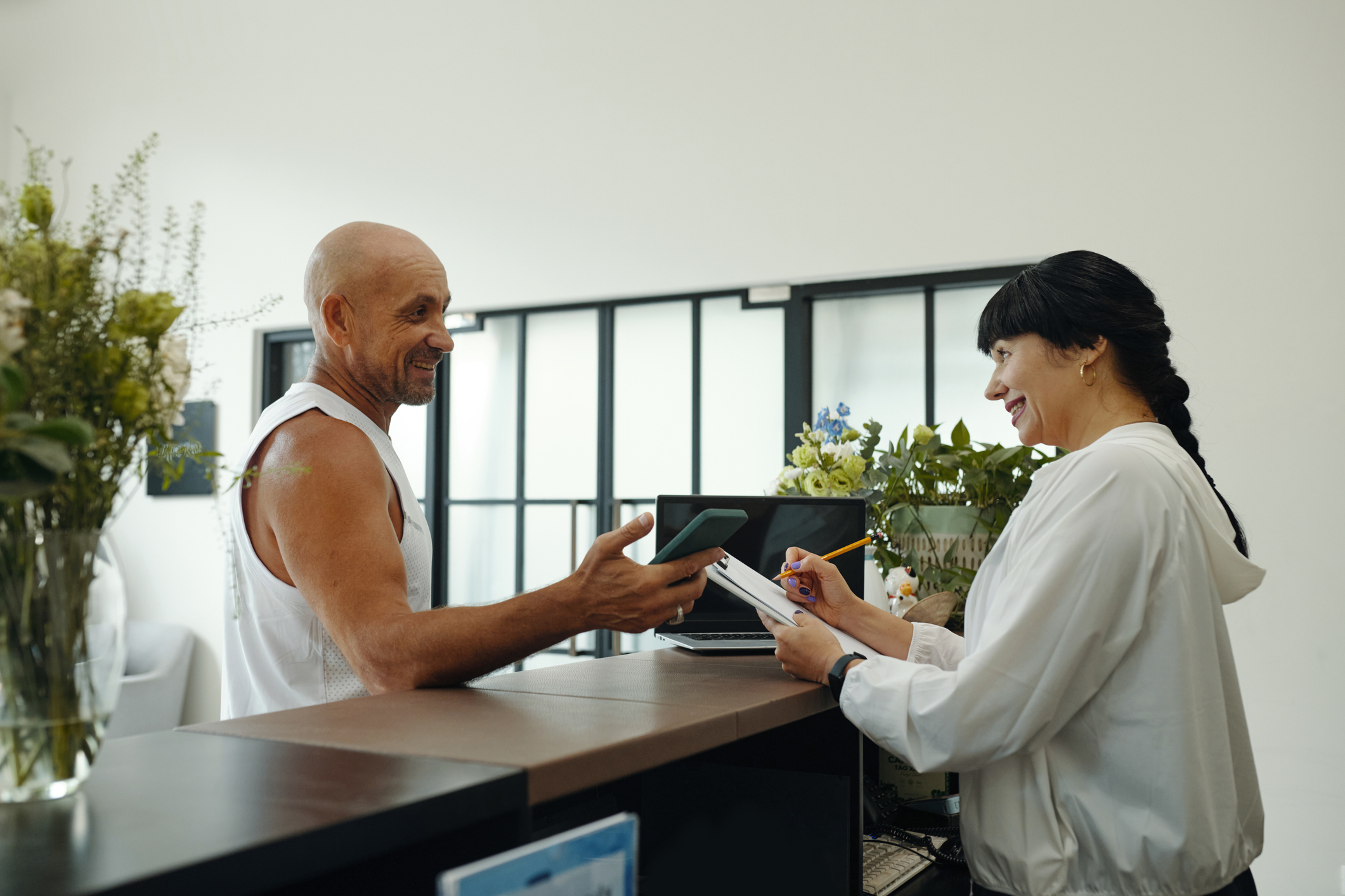 Receptionist Discussing Timetable With Client