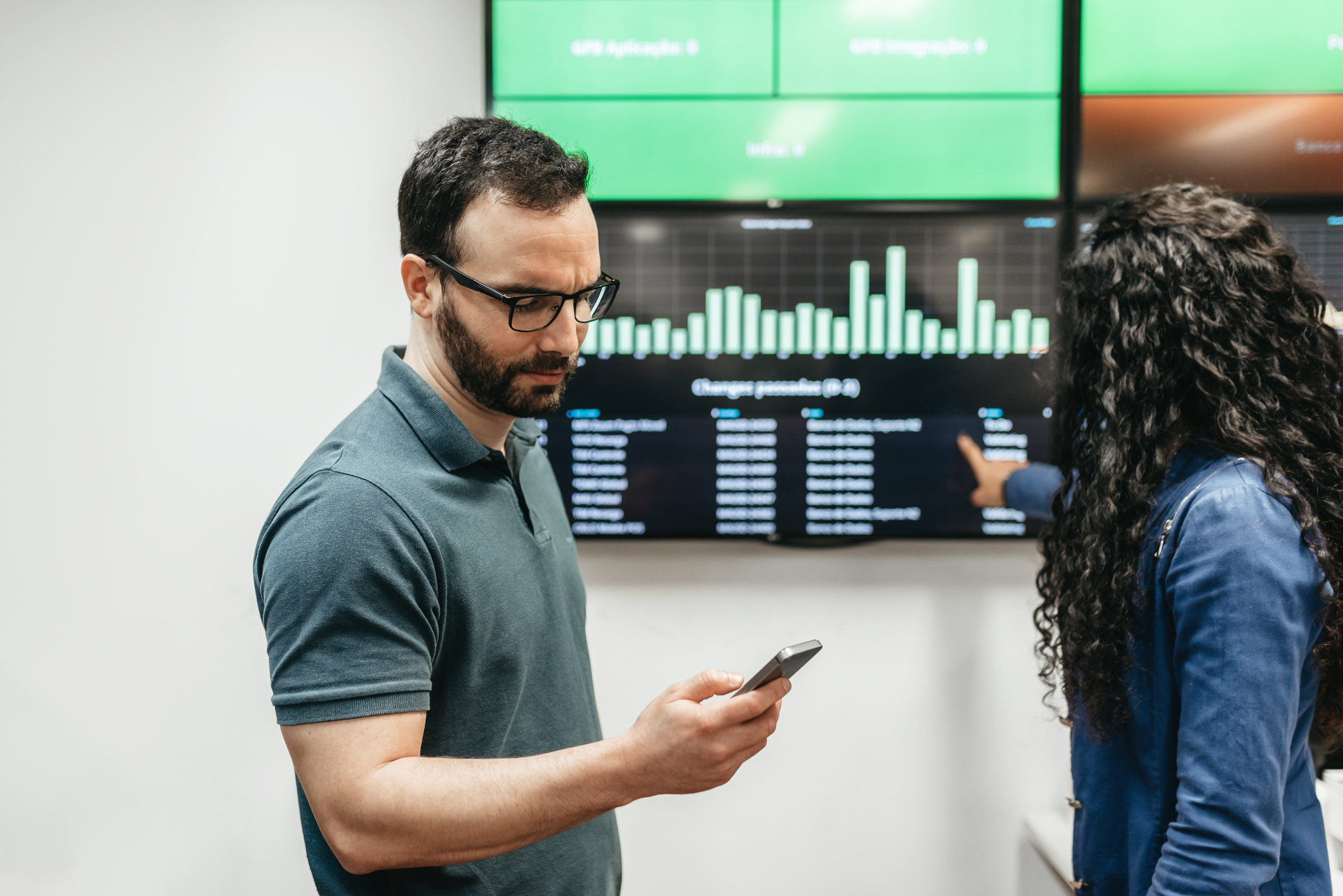 Man and woman checking business data in office