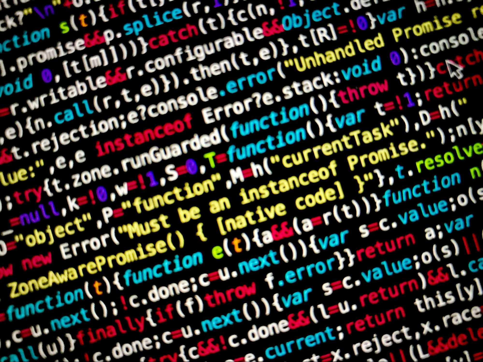 Close-up of colorful programming code on a screen, representing software development and the code complexity that can contribute to technical debt